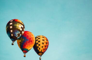 three flying hot air balloons